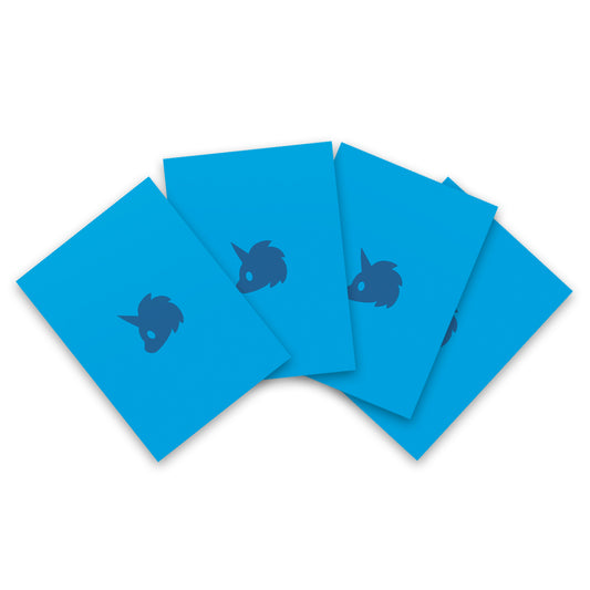 Five blue Tic Tac K.O. Dragons vs. Unicorns: Team Unicorn card sleeves with a dark blue dragon-like creature silhouette printed on them, arranged overlapping on a white background by Unstable Games.