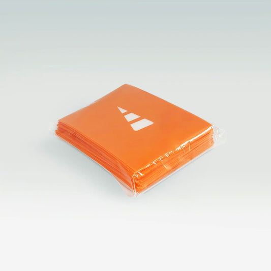 Unstable Games' Orange Card Sleeves showcase a vibrant orange with a sleek white geometric design, neatly wrapped in clear plastic. Enhance your gaming setup with these sleeves that bring Unstable Games' dynamic flair to every session.